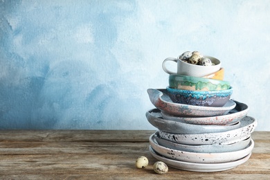 Photo of Composition with dinnerware on table against color background, space for text. Interior element