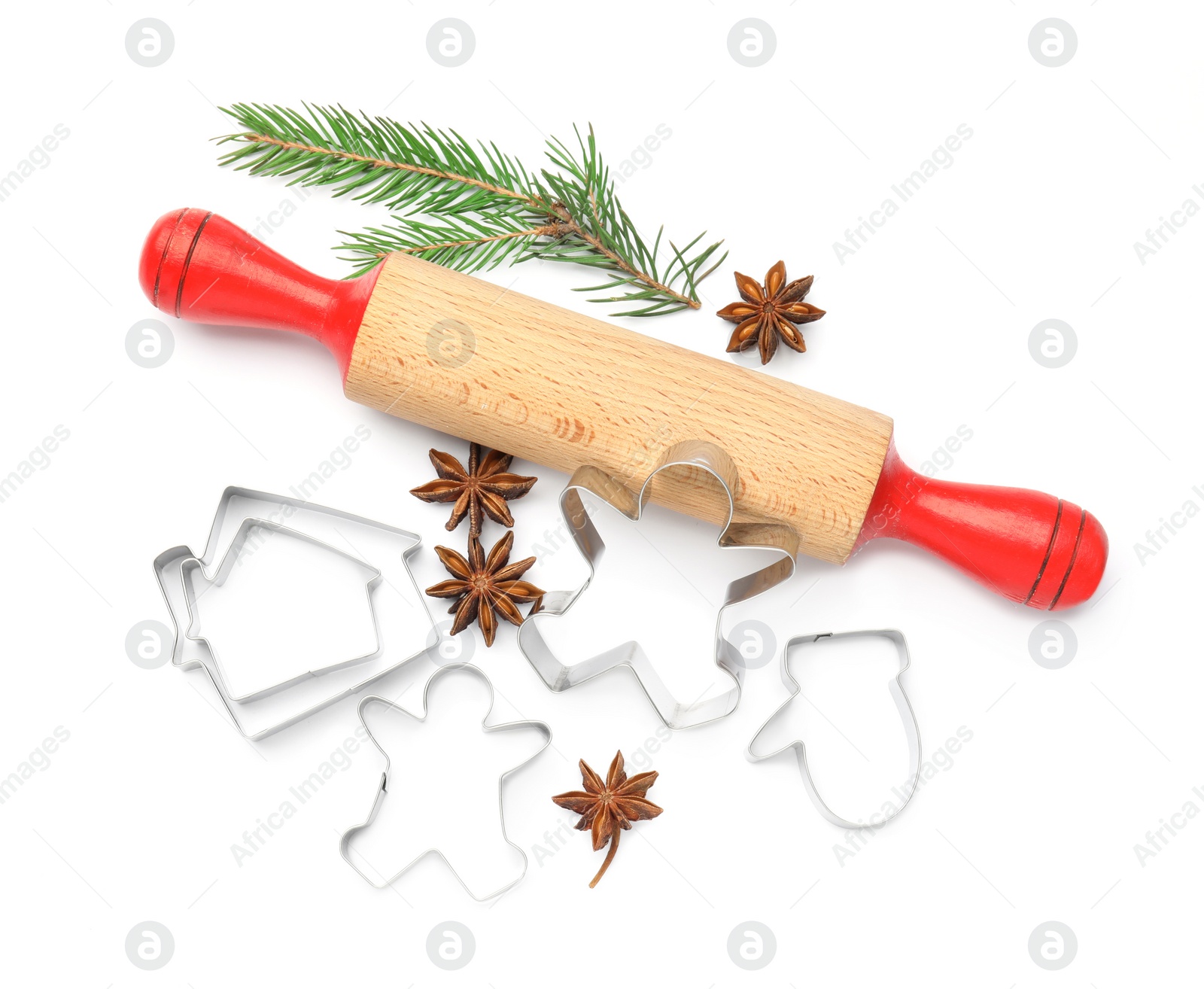 Photo of Cookie cutters, rolling pin, fir branch and anise stars on white background, top view