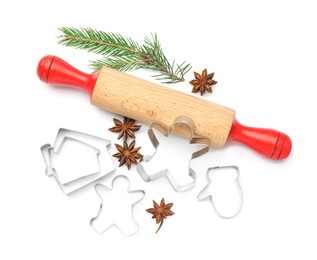 Photo of Cookie cutters, rolling pin, fir branch and anise stars on white background, top view