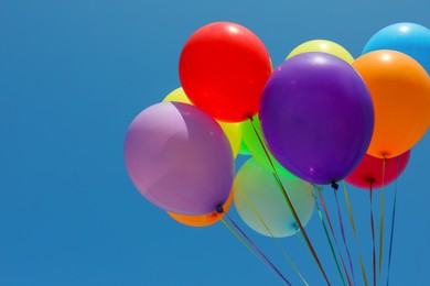 Bunch of colorful balloons against blue sky