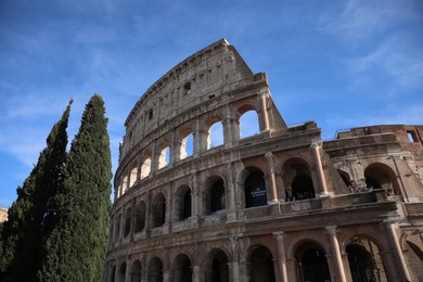 Rome, Italy - February 4, 2024 : Colosseum against light blue sky, low angle view