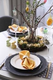 Photo of Beautiful Easter table setting with floral decor indoors