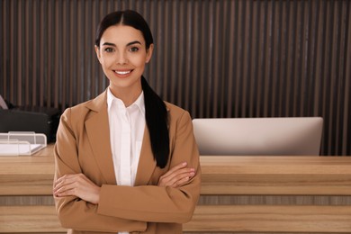 Photo of Portrait of receptionist near countertop in office, space for text