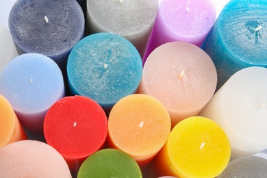 Photo of Different colorful wax candles, close up view