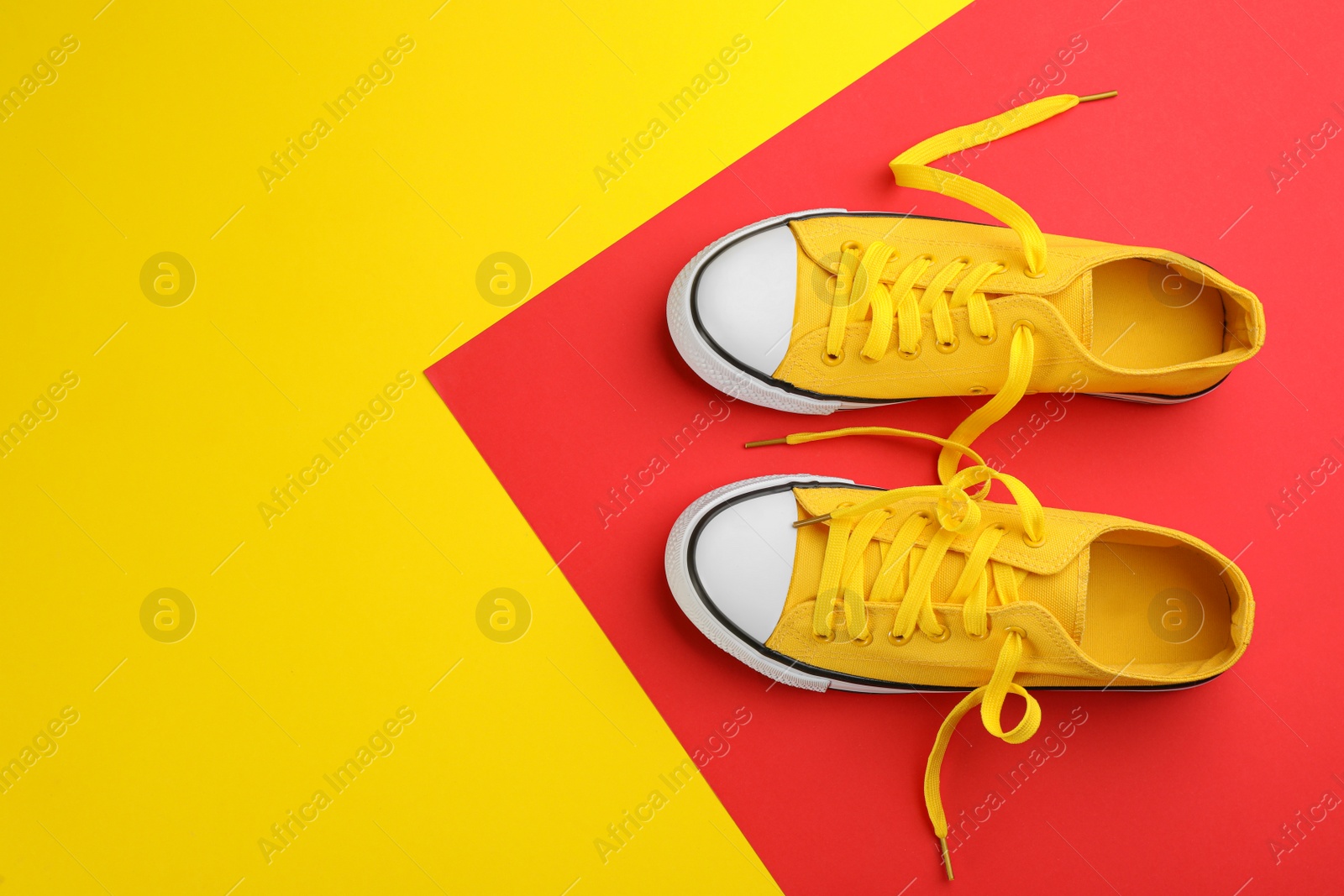 Photo of Pair of trendy sneakers on color background, flat lay. Space for text