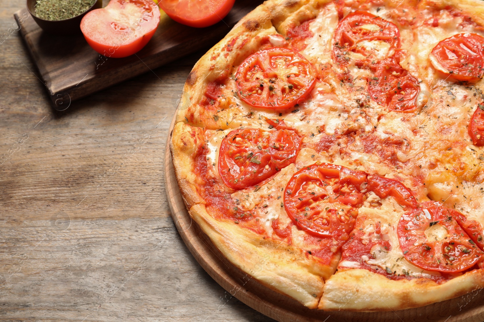 Photo of Hot cheese pizza Margherita on wooden table, closeup. Space for text