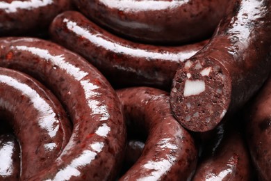 Cut and whole tasty blood sausages as background, closeup view