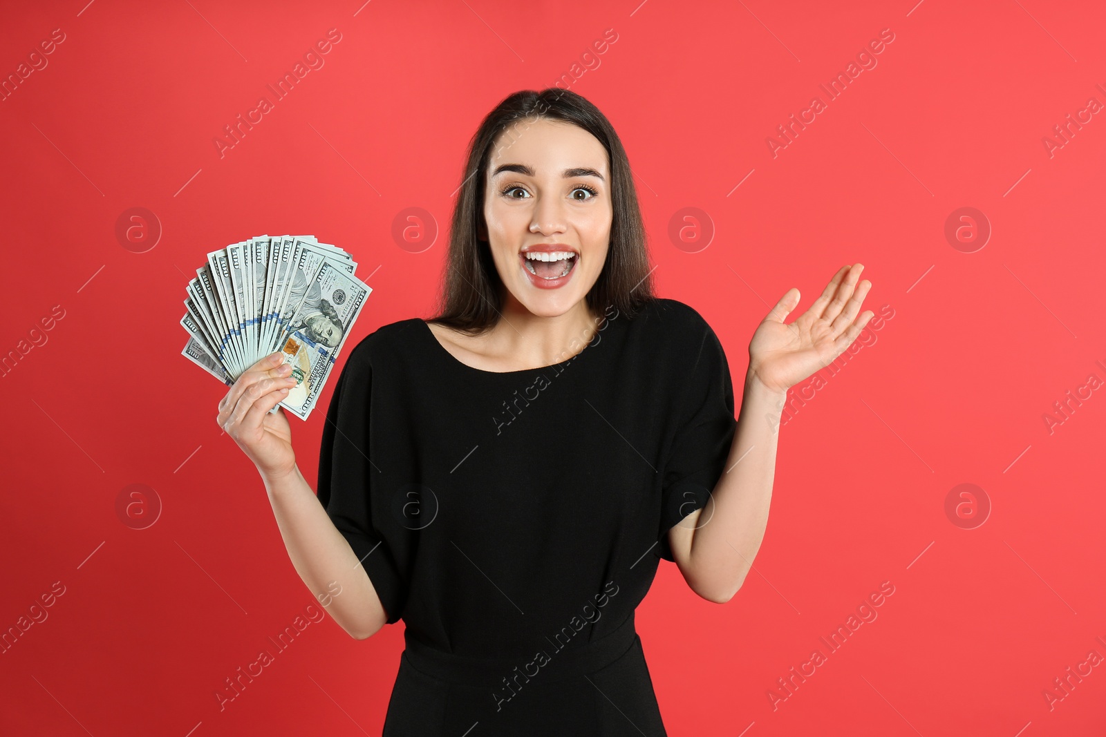 Photo of Emotional young woman with money on crimson background