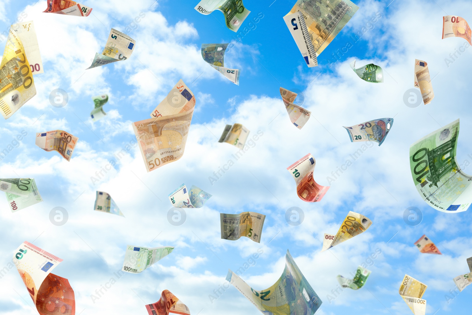 Image of Falling Euro banknotes and blue sky on background. Money rain