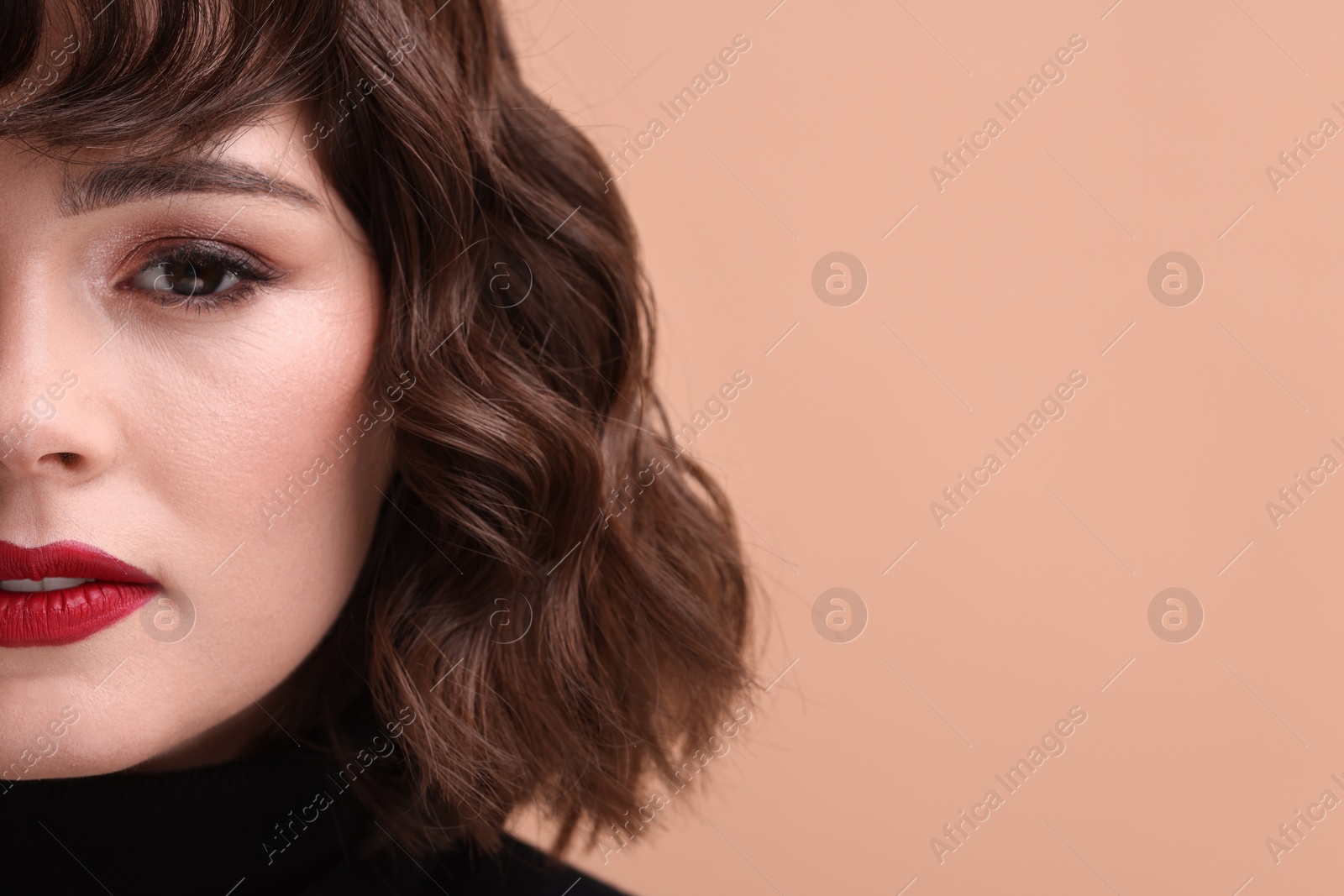 Photo of Beautiful young woman with wavy hairstyle on beige background, closeup. Space for text
