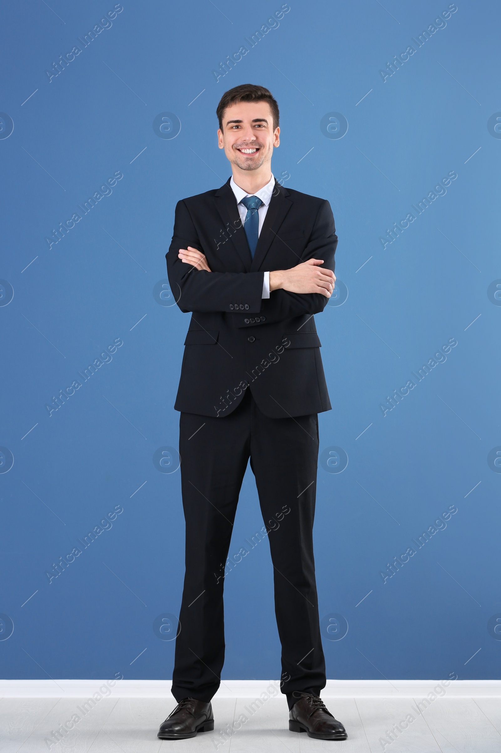 Photo of Business trainer standing on color wall background