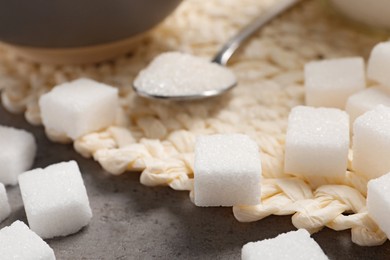 Photo of Cubes of refined sugar on table, closeup