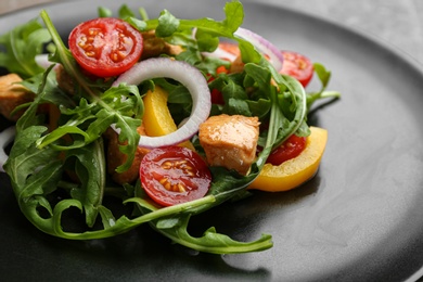 Delicious fresh chicken salad on black plate, closeup