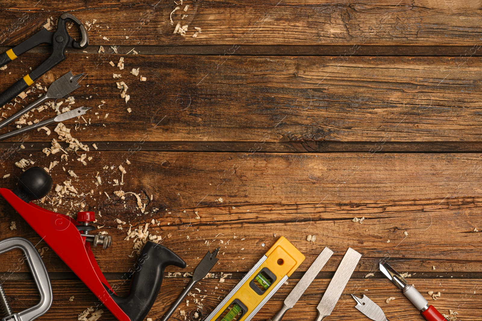 Photo of Flat lay composition with carpenter's tools on wooden background. Space for text