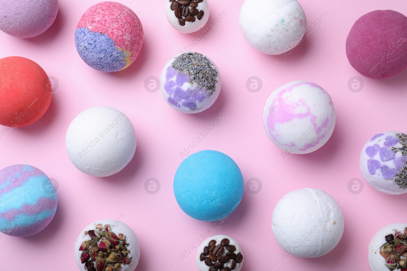 Photo of Colorful bath bombs on pink background, flat lay