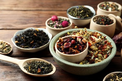 Photo of Many different herbal teas on wooden table