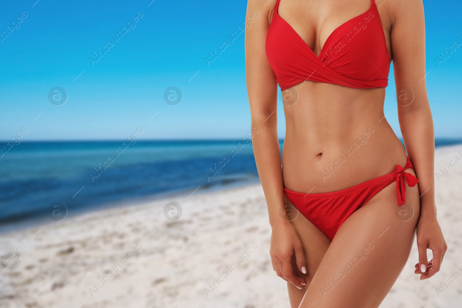 Image of Pretty sexy woman with slim body in stylish bikini at beach on sunny day, closeup. Space for text