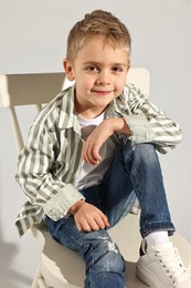 Photo of Fashion concept. Stylish boy on light grey background