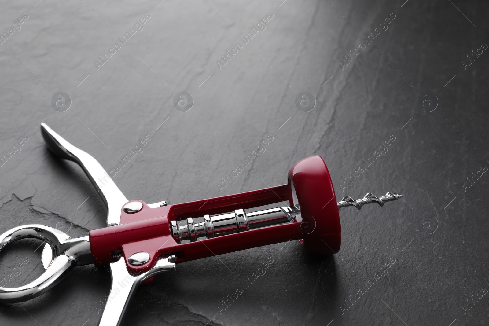 Photo of One wing corkscrew on grey textured table, closeup