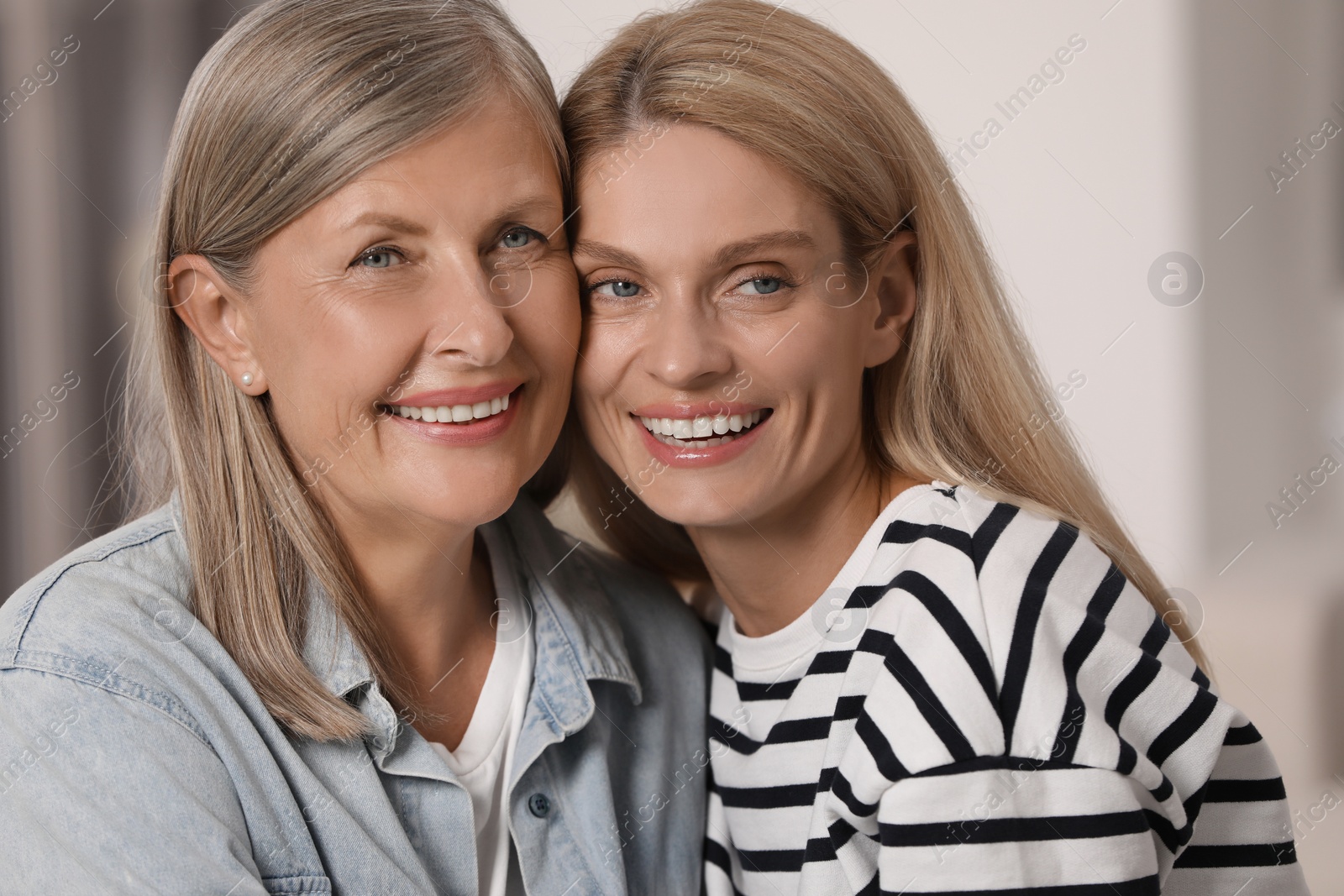 Photo of Happy daughter and her mature mother indoors