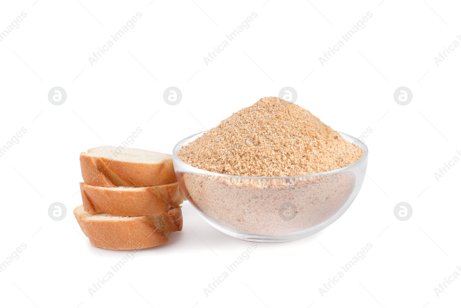 Photo of Fresh bread crumbs in glass bowl and slices of loaf on white background