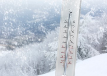 Image of Thermometer showing temperature below zero outdoors on winter day