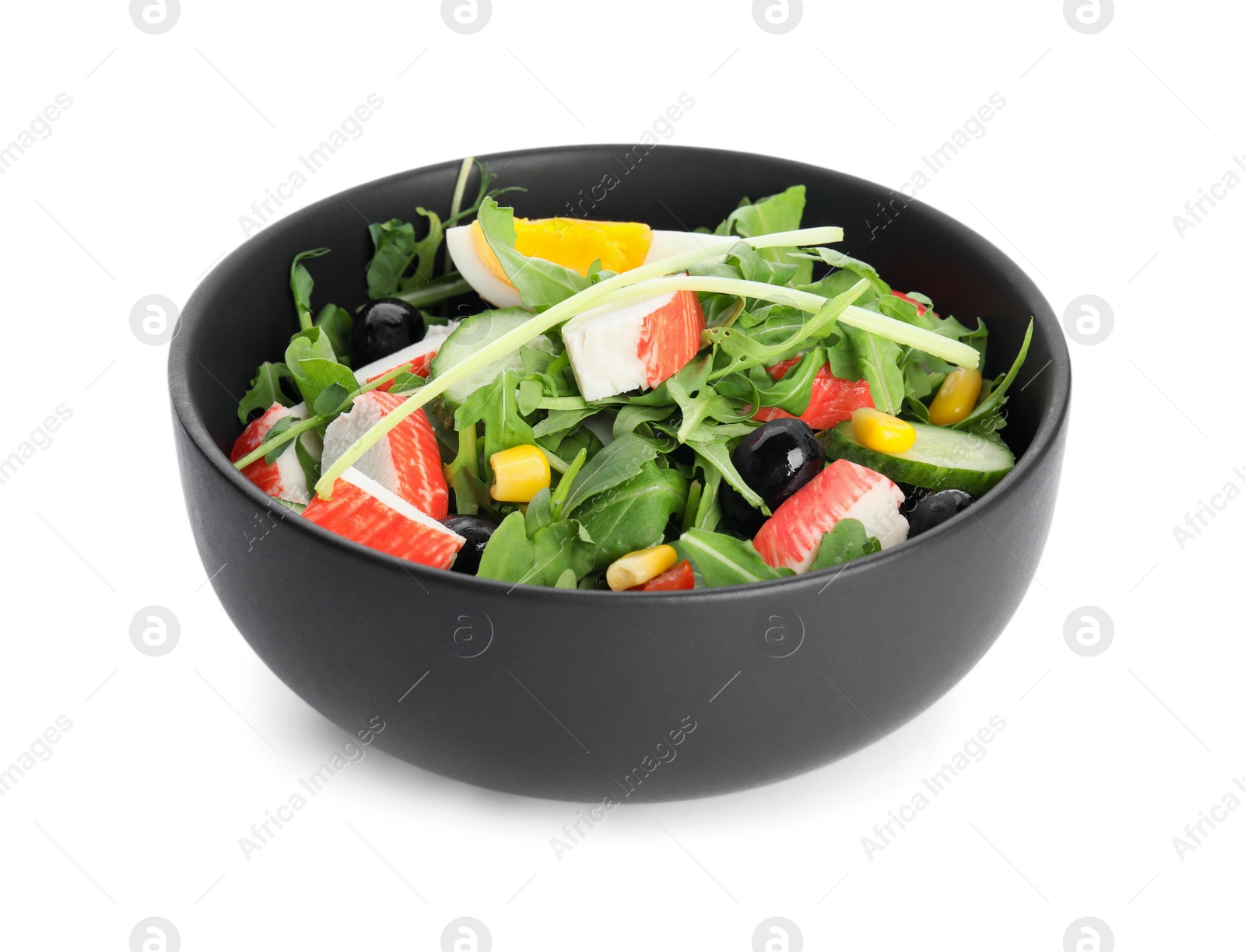 Photo of Tasty crab stick salad in bowl isolated on white