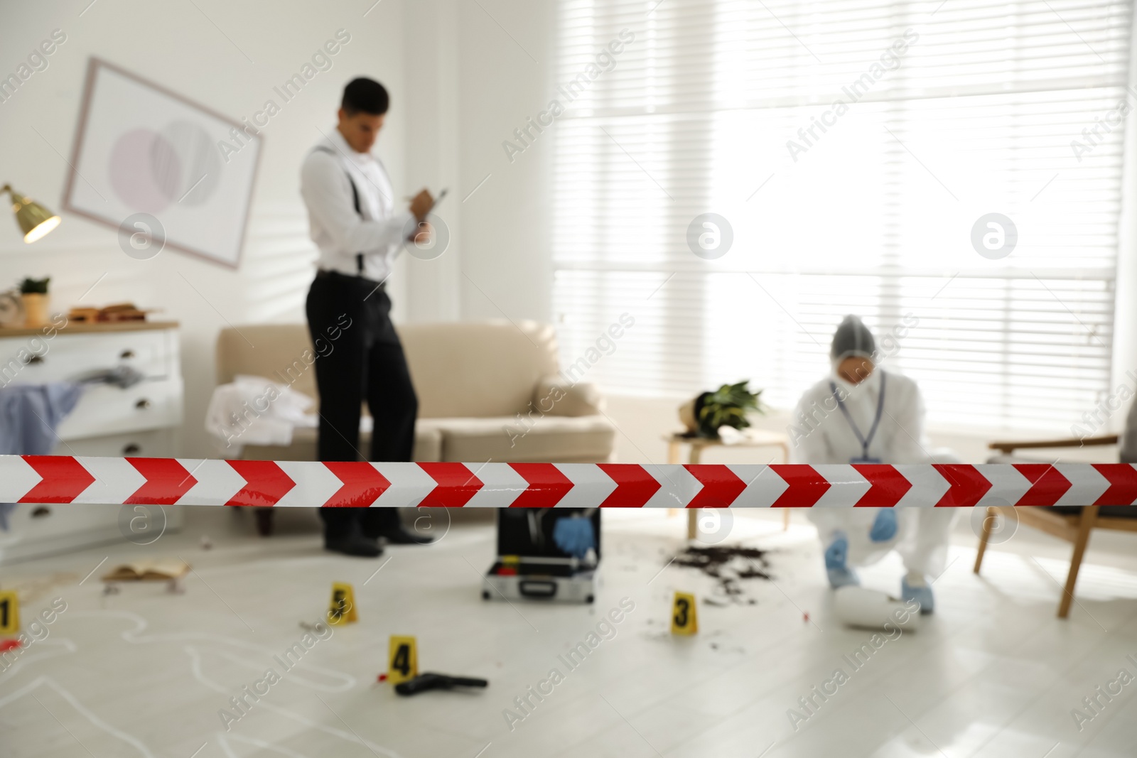 Photo of Investigators working at crime scene in living room