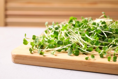 Fresh organic microgreen on white table, closeup