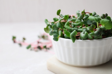 Photo of Fresh organic microgreen on white table, closeup