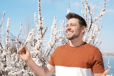 Photo of Happy healthy man enjoying springtime outdoors. Allergy free concept
