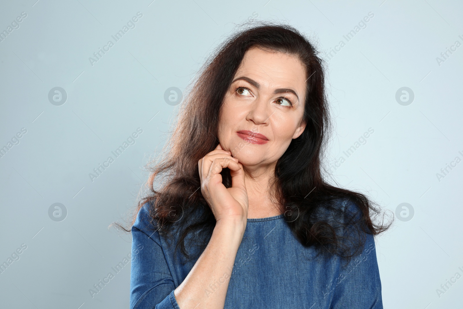 Photo of Portrait of mature woman with beautiful face on grey background