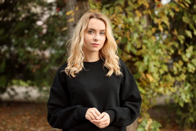 Photo of Beautiful woman in stylish warm sweater outdoors