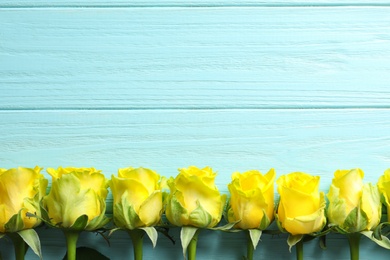 Flat lay composition with beautiful blooming flowers on wooden background