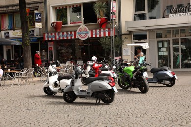 Photo of Cologne, Germany - August 28, 2022: View of city street with parked modern motorbikes