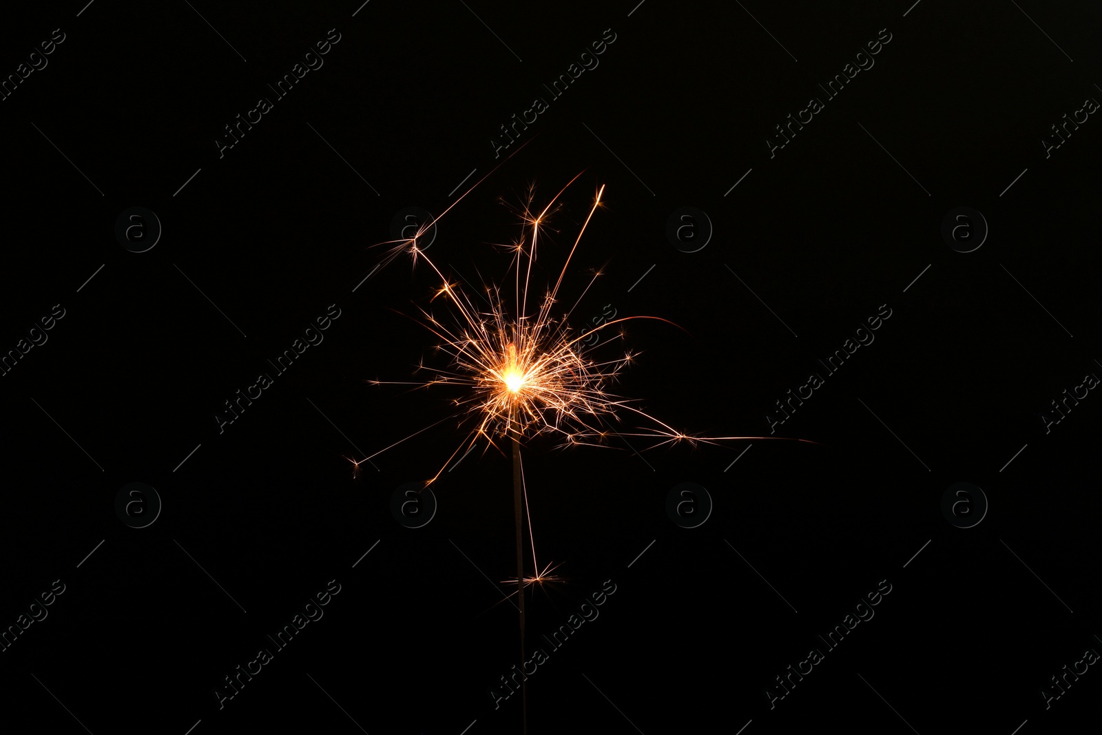 Photo of Burning sparkler stick on black background, space for text