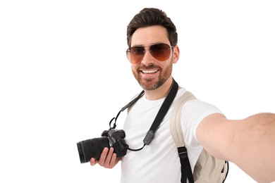 Smiling man with camera taking selfie on white background