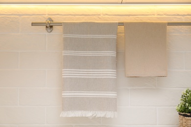 Photo of Clean kitchen towels hanging on wall indoors