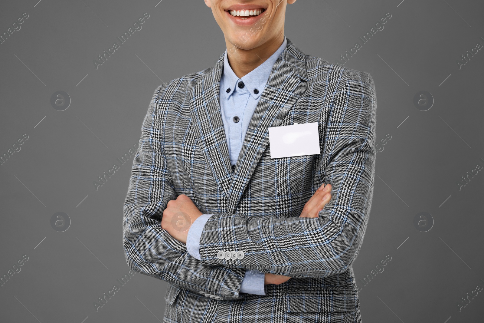 Photo of Man with blank badge on grey background, closeup