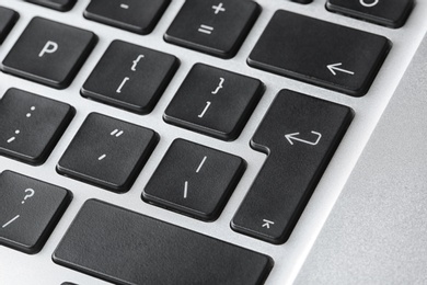 Modern laptop keyboard with black buttons, closeup view