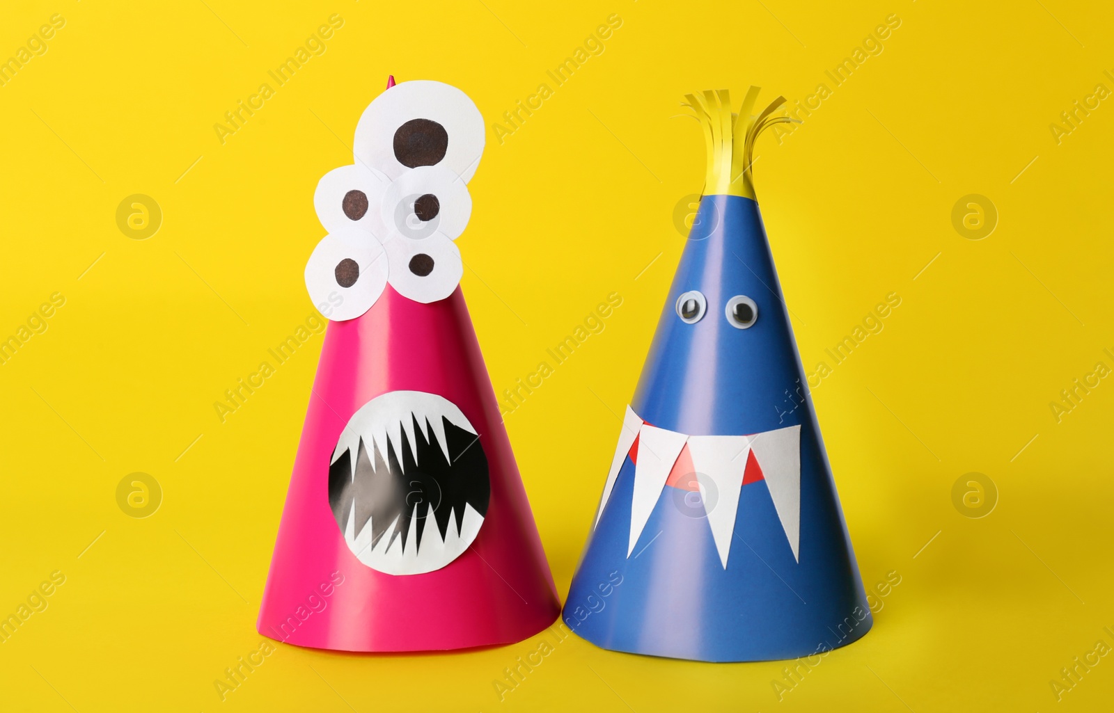 Photo of Funny monsters on yellow background. Halloween decoration