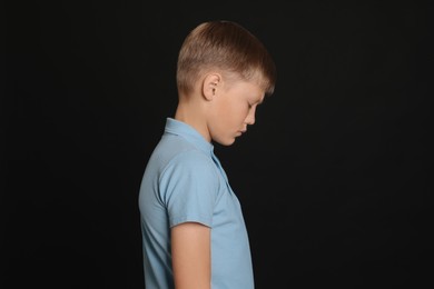 Photo of Lonely boy on black background Children's bullying