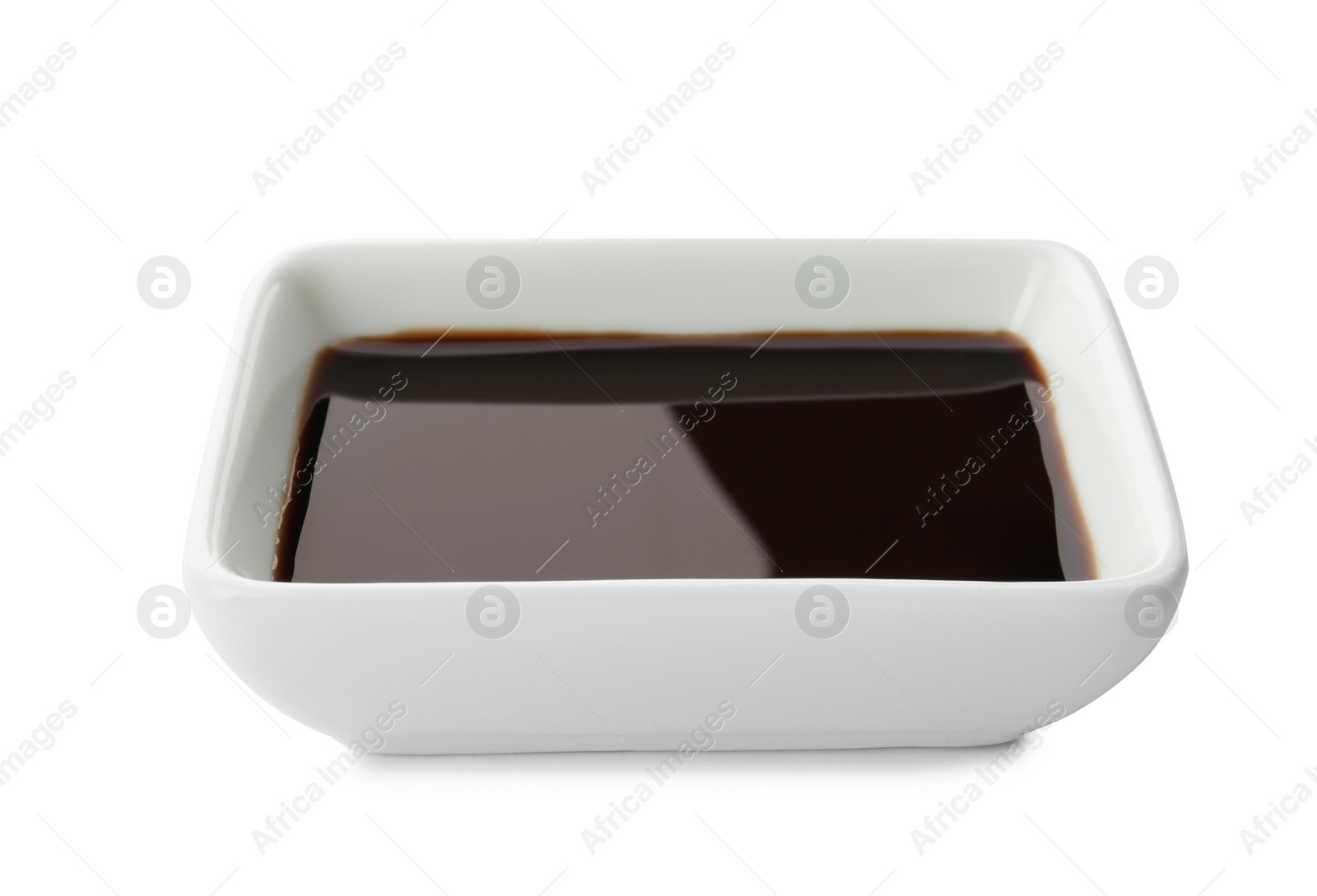 Photo of Dish of soy sauce on white background