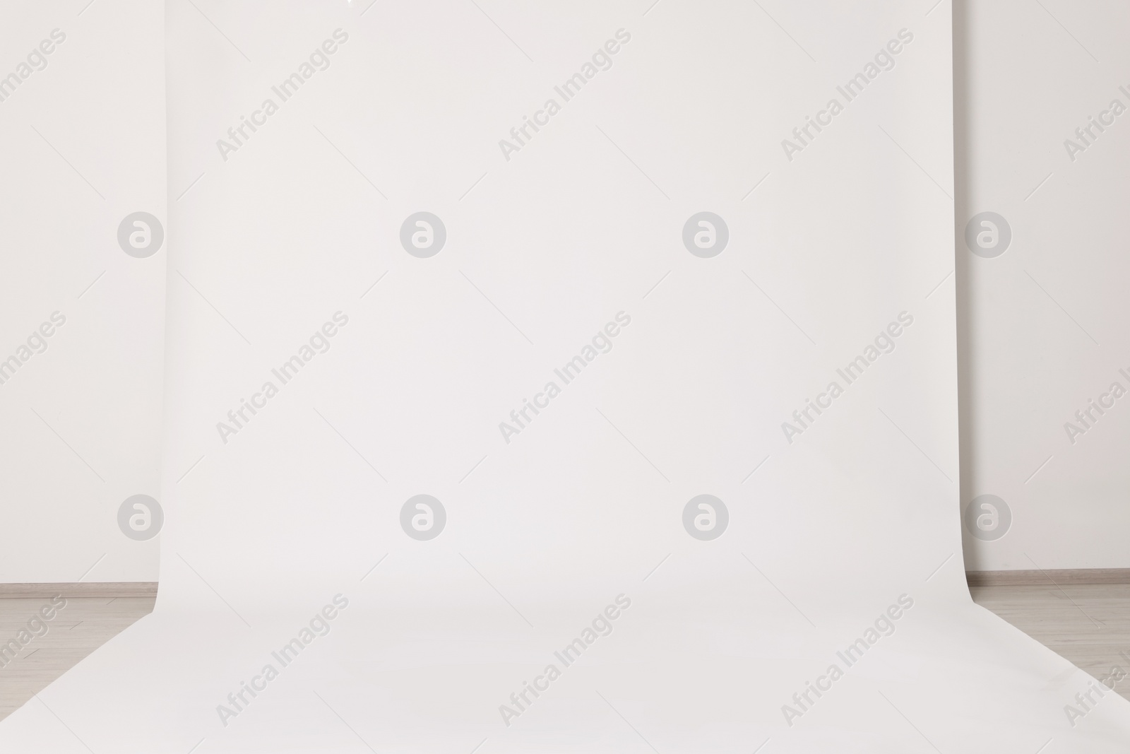 Photo of Modern white photo background. Professional studio equipment