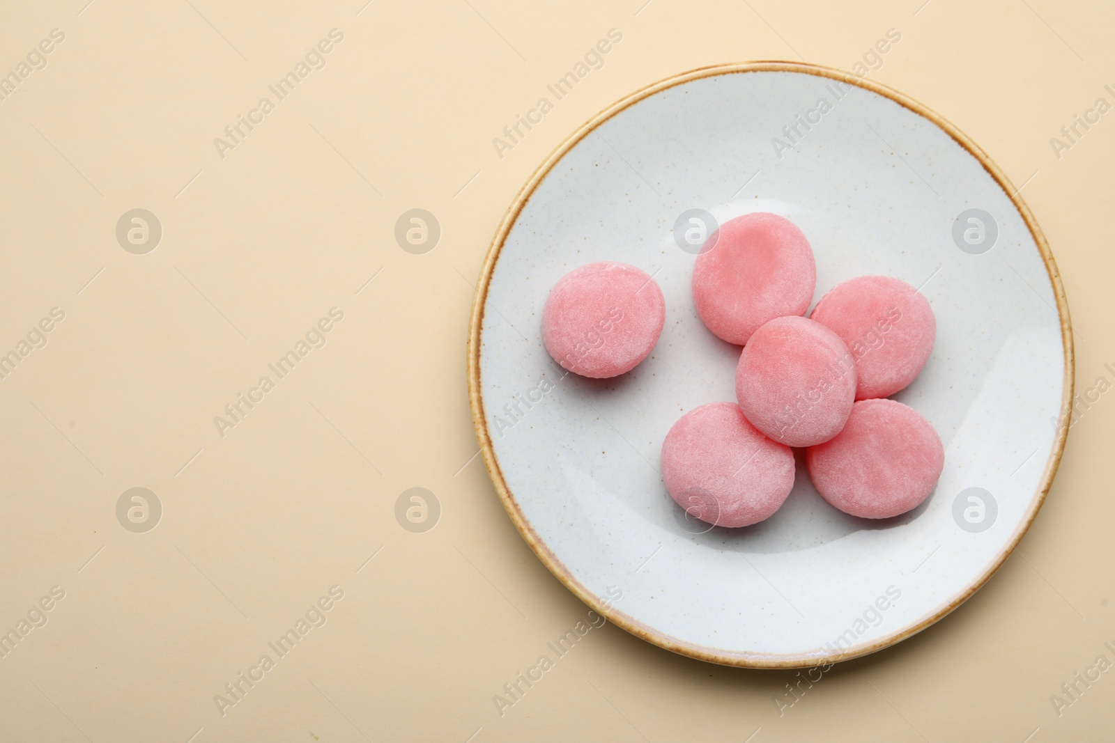 Photo of Plate with delicious mochi on beige background, top view. Space for text