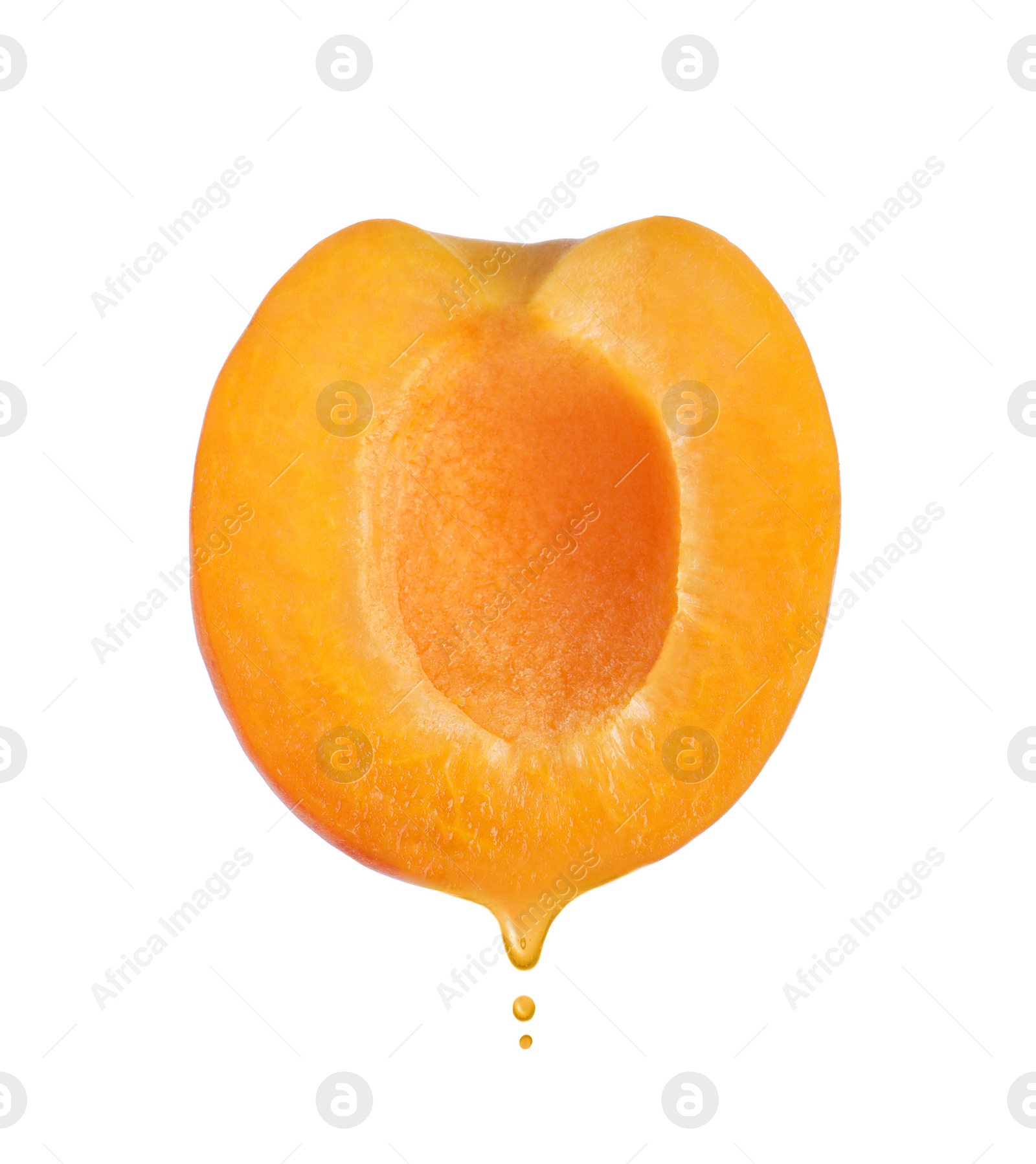 Image of Apricot oil dripping from fresh fruit half on white background