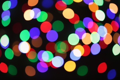 Photo of Beautiful colorful lights on dark background. Bokeh effect