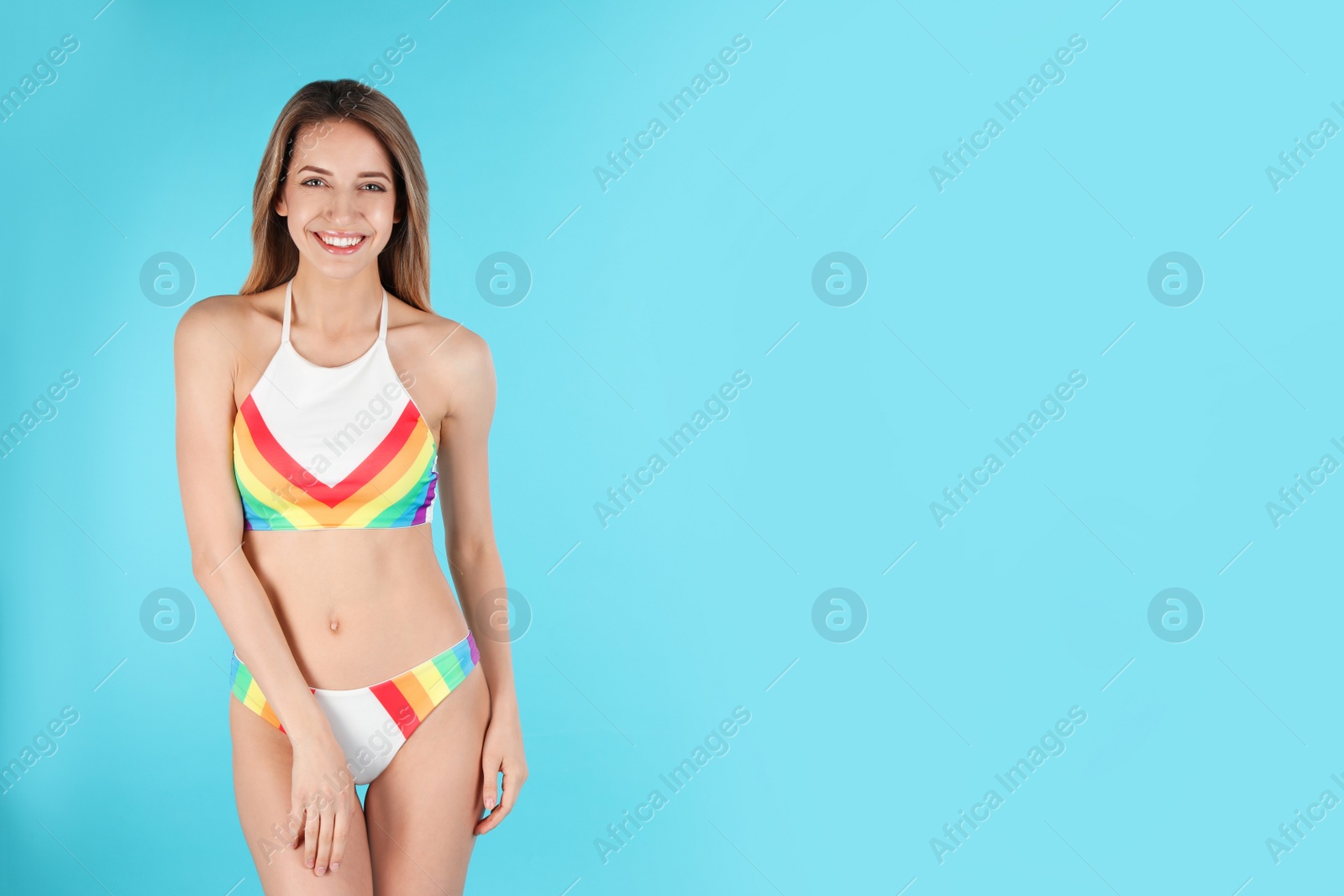 Photo of Young slim woman in bikini on color background, space for text. Perfect body