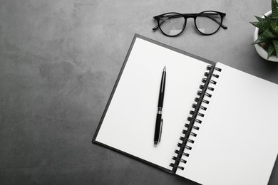 Flat lay composition with notebook on grey table