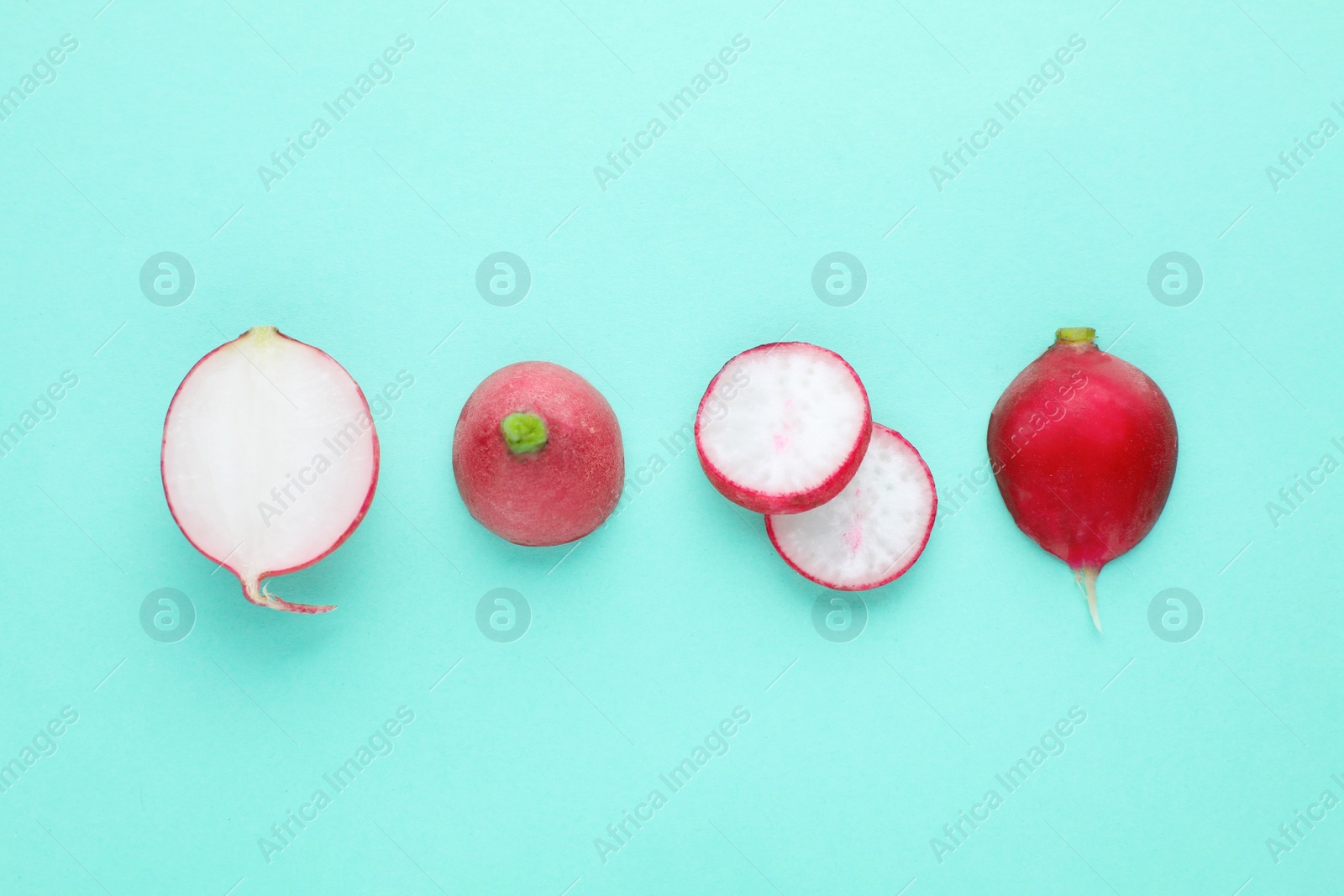 Photo of Fresh ripe radish on turquoise background, flat lay